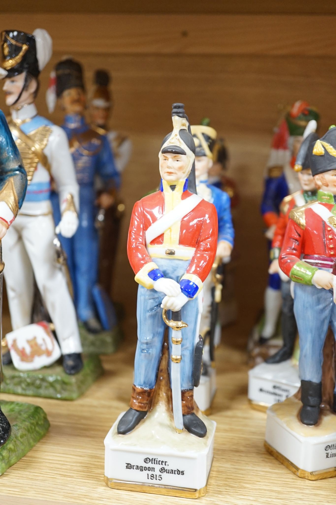 A collection of Continental porcelain figures of military soldiers, tallest 27.5cm